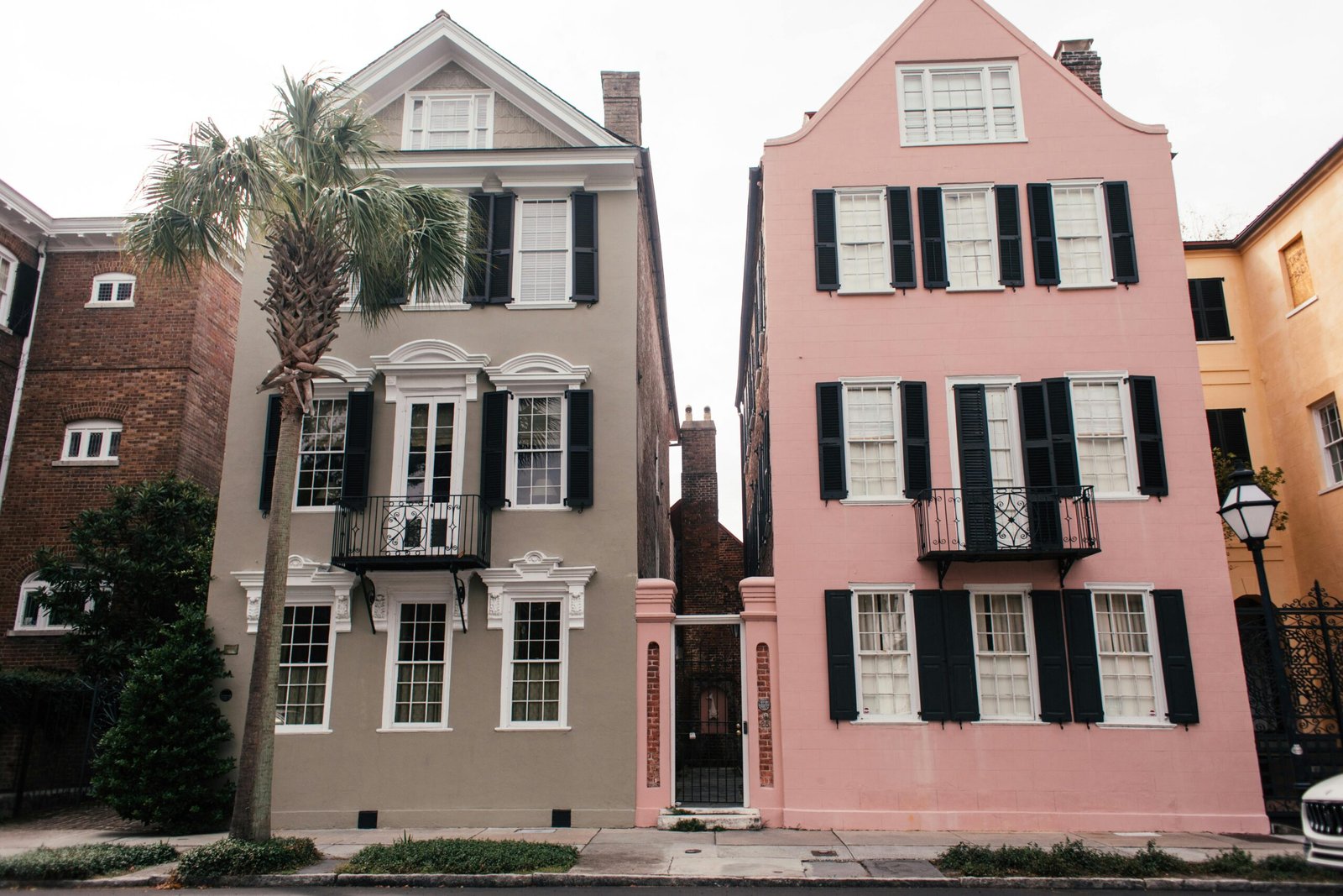 Beautiful pink and gray historic homes in Charleston's iconic neighborhood.